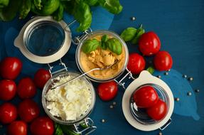 feta cheese, tomatoes and basil on the table