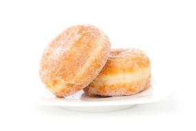 Beautiful Berliner donuts with sugar powder, on the white plate