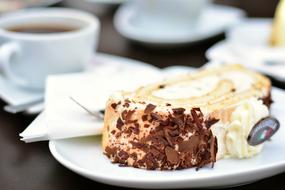 roll with butter cream on a plate on a table in a cafe