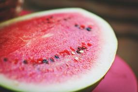 ripe cut watermelon close up on blurred background