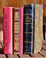 Colorful and beautiful, antique cookbooks, on the wooden surface