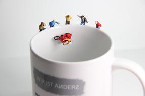 miniature figurines of people on a cup