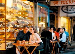 couple in love laughing in a street cafe