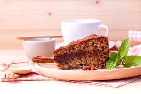 a piece of delicious cake and a cup of coffee on the table