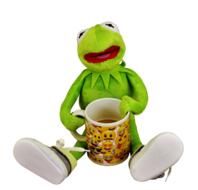 Kermit sits with a cup of coffee