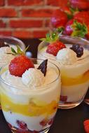 Beautiful and colorful quark cream with fruits, near the brick wall