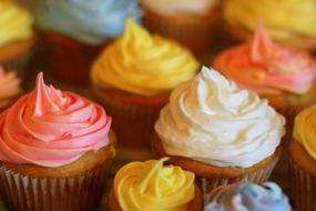Cupcakes with Colorful cream topping close-up on blurred background