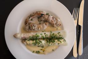 chicken with asparagus in a creamy sauce on a plate