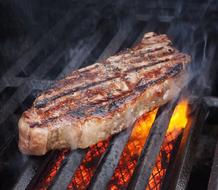 Steak of Meat on grill