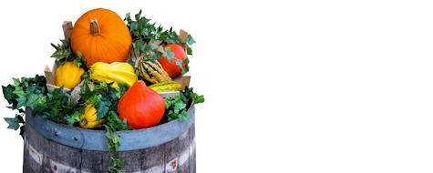 autumn harvest of vegetables in a wooden barrel on a white background