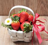 ripe strawberries in a white wicker basket as still life