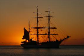 silhouette of a vintage ship at dusk