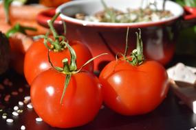 photo of red tomatoes on the background of the pan