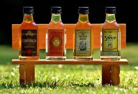 four Bottles with Alcohol on bench