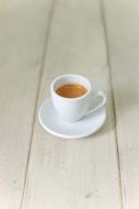 Coffee Espresso in a white cup on a wooden table