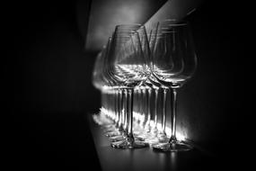 two row of empty Wine Glasses at darkness