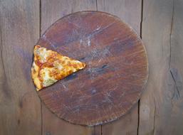 slice of italian pizza on a wooden tray