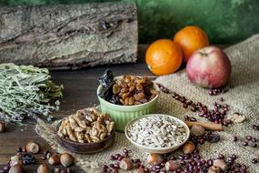 dried fruits, nuts and herbs lie on the table