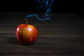 apple as a candle on dark