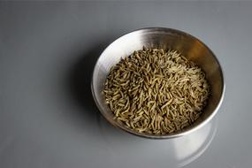caraway seeds in metal bowl