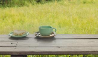 Coffee and dessert on wooden table outdoor