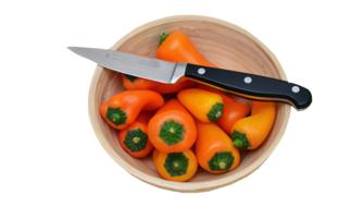 knife on a plate with bell peppers