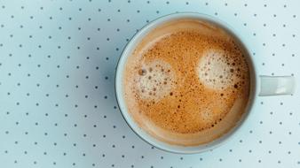 coffee with foam on the table with polka dots