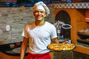 chef with pizza in his hands in the kitchen