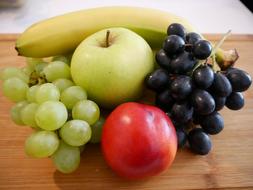 ripe fruits on wood kitchen board