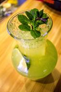 refreshing drink with mint in a glass decanter