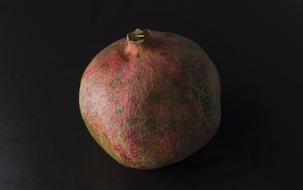 Close-up of the beautiful red pomegranate at black background