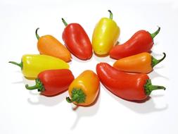 yellow, red and orange peppers on a white background