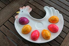 Beautiful, colorful, shiny Easter eggs, on the shiny, colorful chicken plate