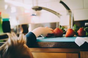 kid eating strawberries