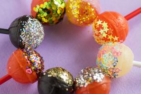chupa chups candies with colored sequins