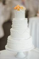 white wedding cake on blurred background