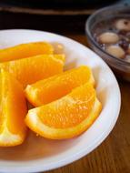 slices of bright orange on a white plate