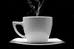 White coffee cup with steam at black background