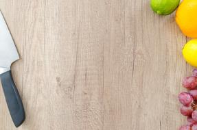 knife and fruit on a wooden cutting board