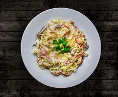 carbonara pasta with sauce in a plate on the table