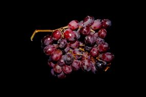 red Grapes at black background