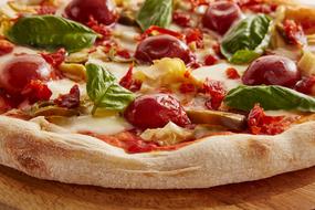 baked pizza with tomatoes and herbs