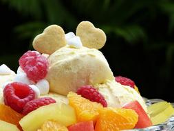 ice cream with cookies and fruits on blurred background