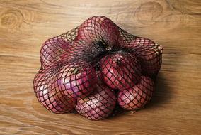 Big red Onions in mesh bag