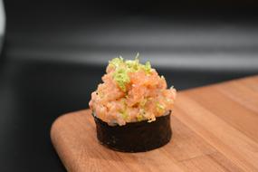 photo of japanese sushi with fish on a wooden cutting board