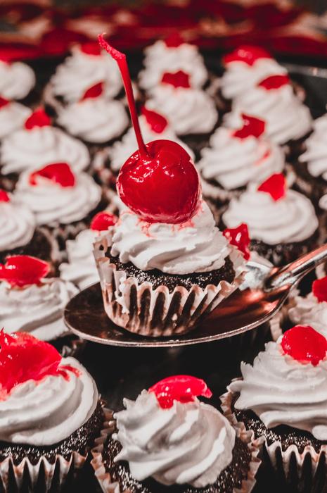 many cupcakes with cherries