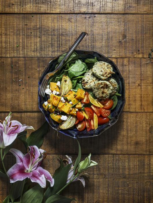vegetable dish on a plate and purple lilies