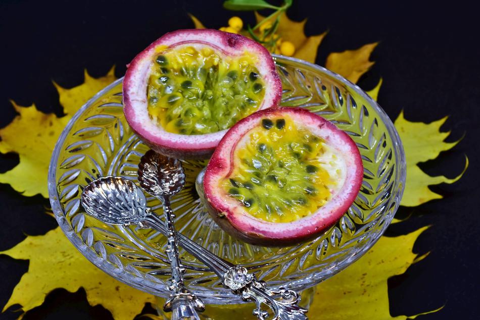 delicious Passion exotic fruit with the spoons on the plate
