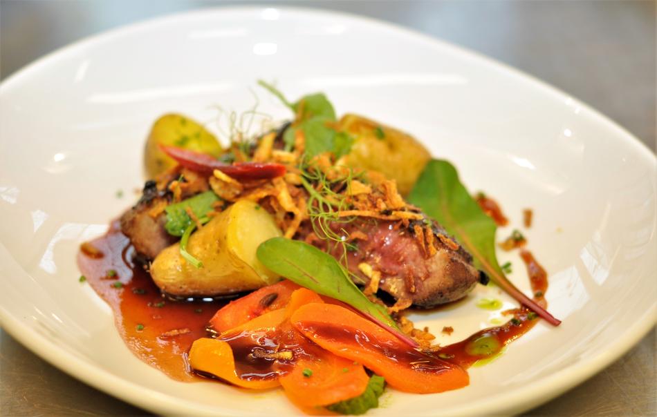Colorful and beautiful duck with vegetables on the white, shiny plate