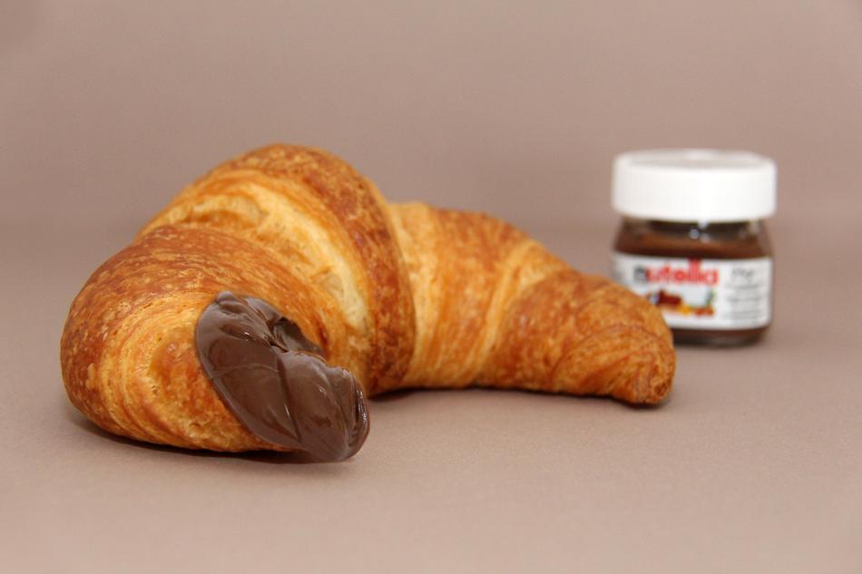 croissant and nutella in blurred background